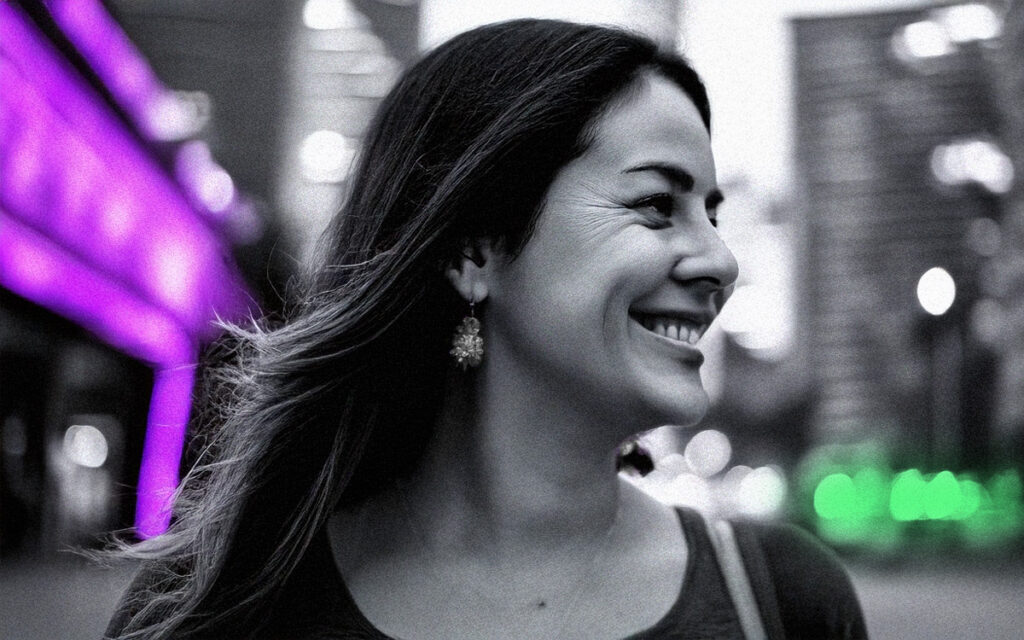 Relaxed woman walking down the street and looking to her left