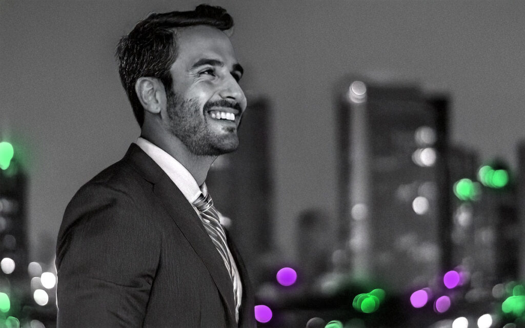 Smartly dressed corporate man in a tie and suit with business district background