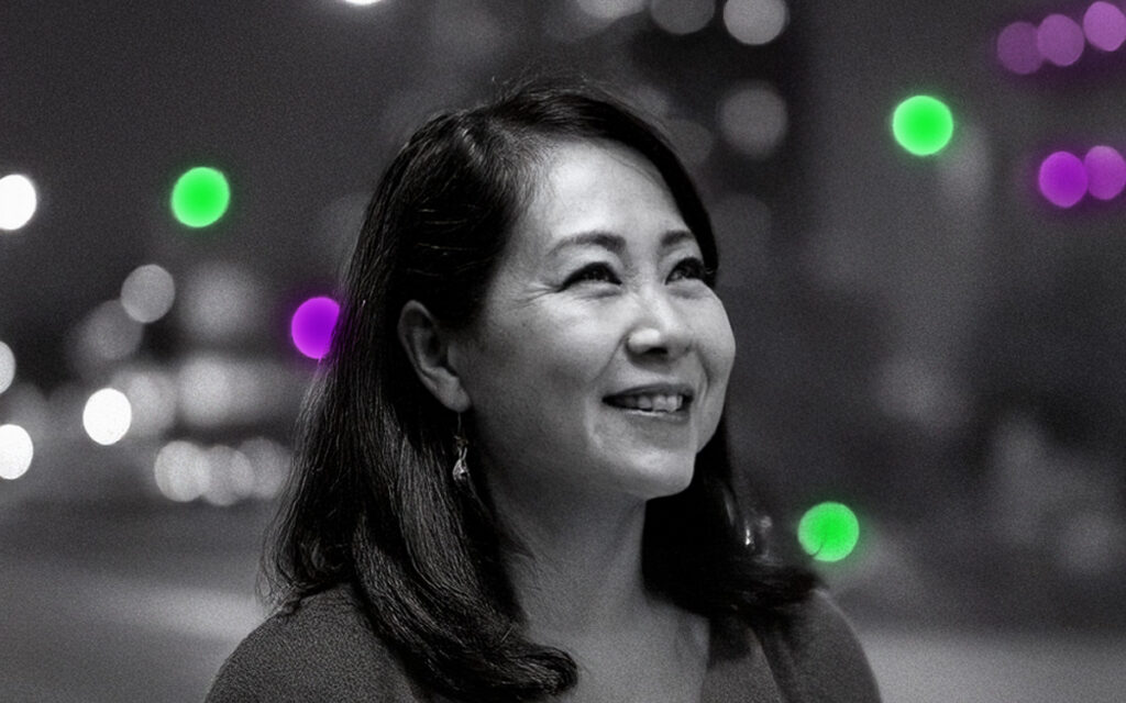 Woman photographed on street in a natural pose with blurred lighting