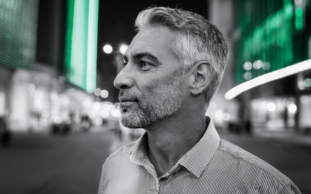 Man on street in a striped shirt