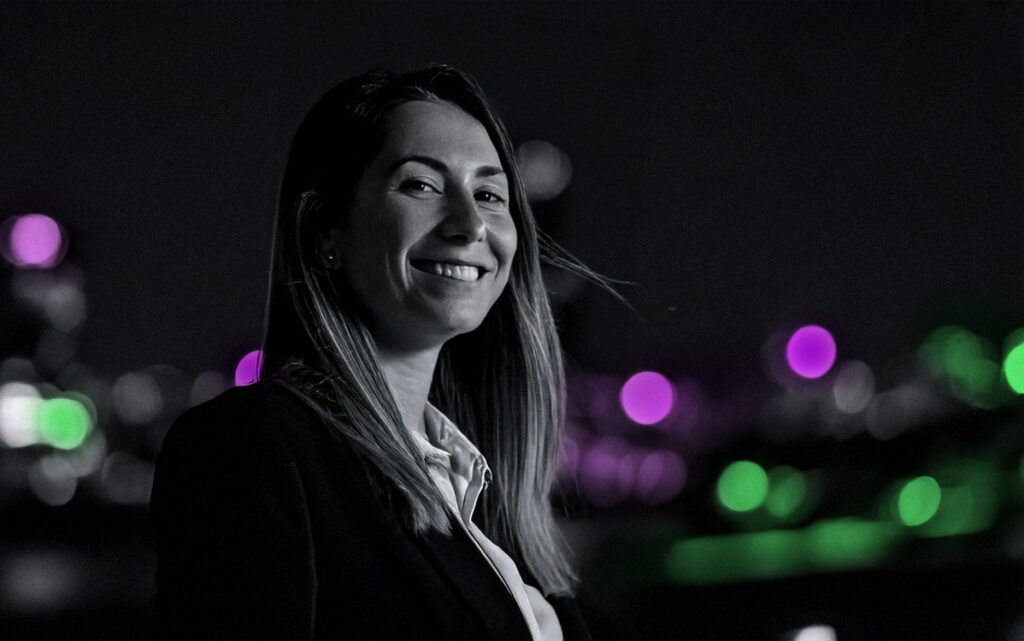 Portrait shot of woman in business attire outside, hair blowing in wind