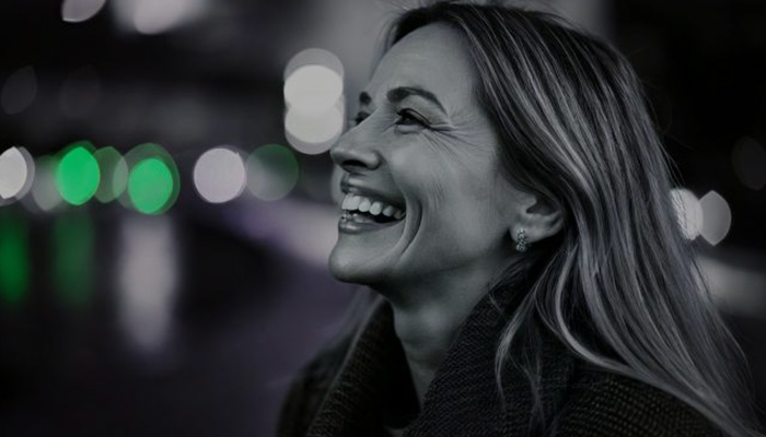 Laughing older woman looking relaxed after work