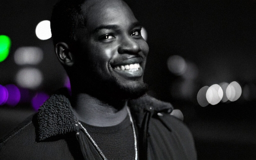 Relaxed and smiling man in t-shirt and jacket.